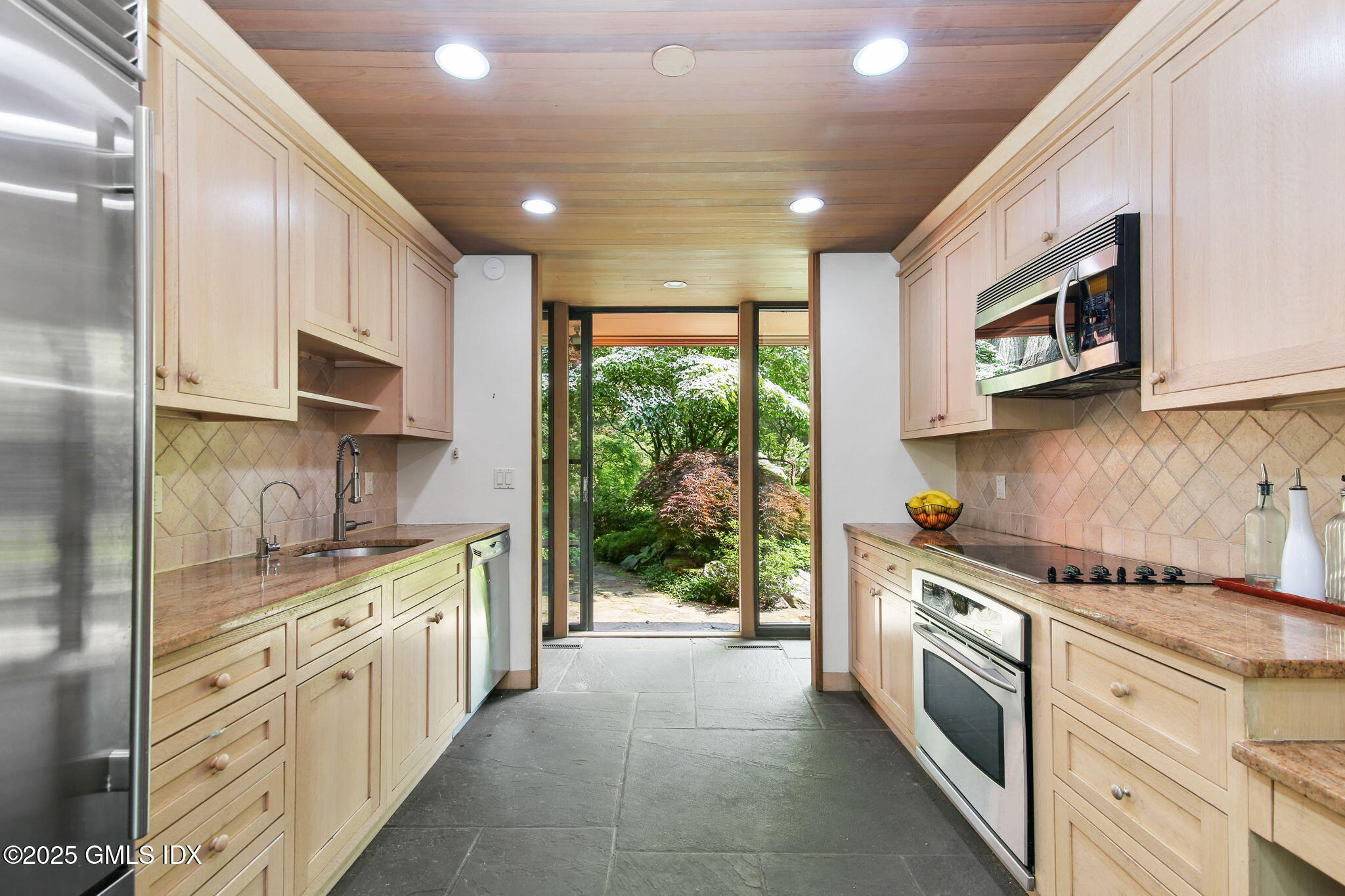 21 Hycliff Road Greenwich, CT 06831 - Photo 7 of 25 a kitchen with stainless steel appliances granite countertop a stove a sink and a microwave