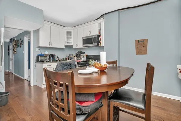 a dining room with furniture and wooden floor