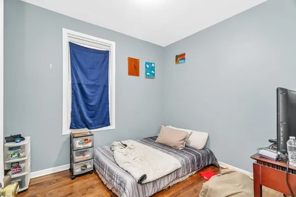 a room with two bed and a window
