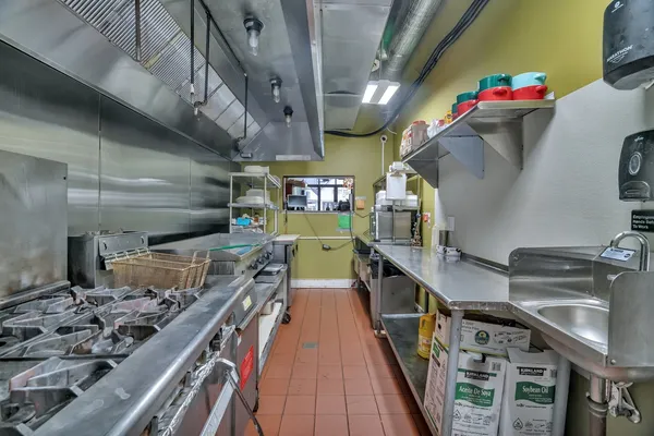 a kitchen with wooden cabinets and a stove