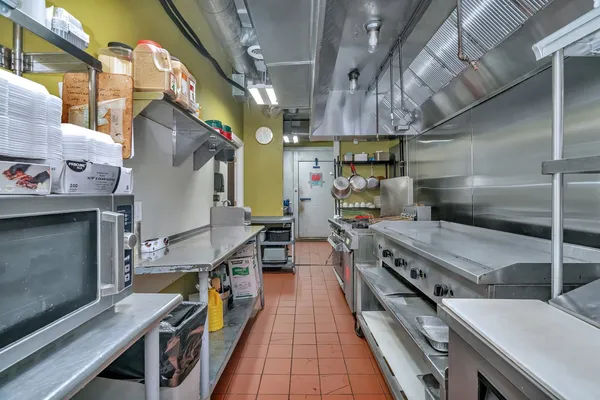 a kitchen with stainless steel appliances a sink and a refrigerator