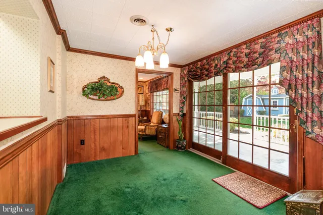 a living room with furniture a flat screen tv and next to a window