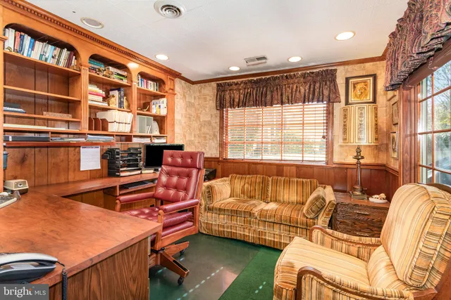 a spacious bedroom with a bed and a chandelier
