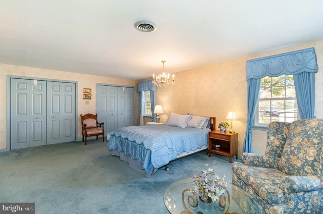 a spacious bedroom with bed and window