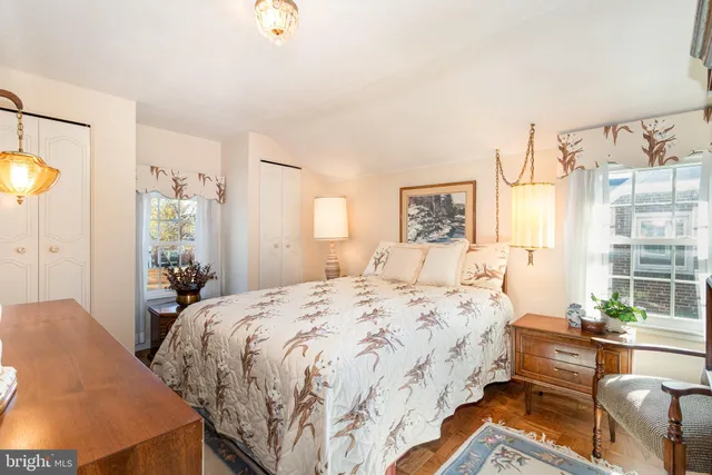 a bedroom with a bed a dresser and a window