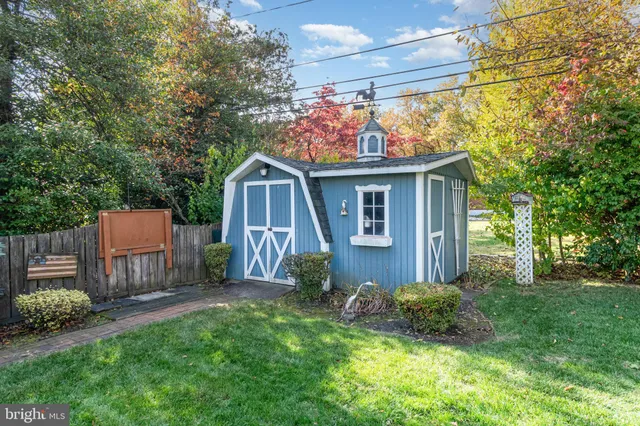 a view of a patio with table and chairs under an umbrella