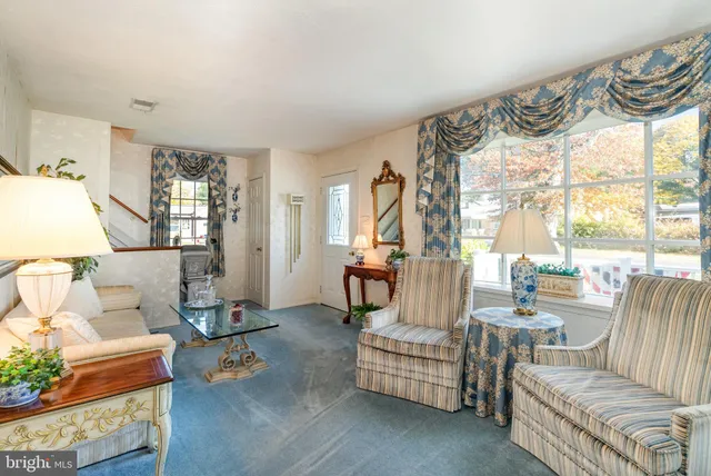 a view of a dining room with furniture a chandelier and wooden floor