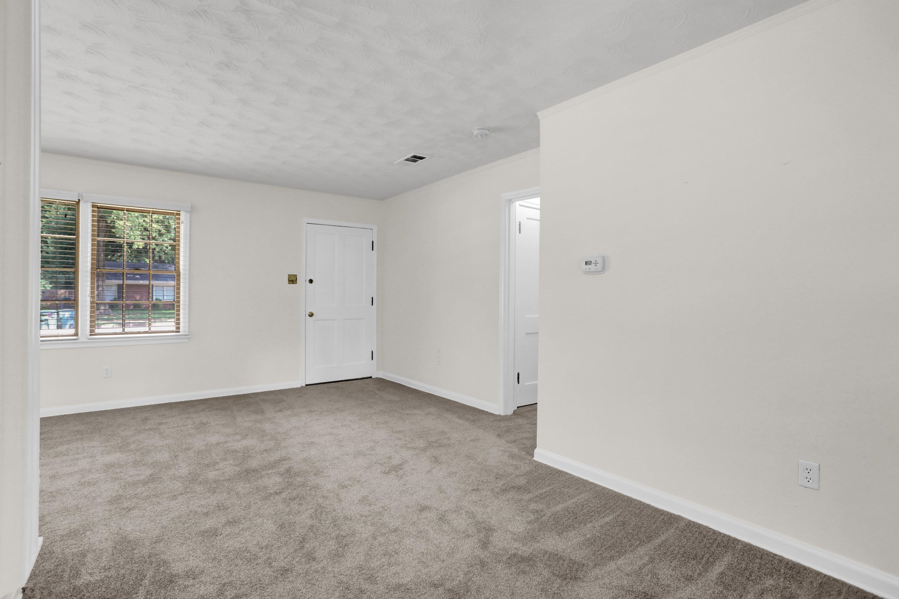 4545 Flamingo Road Memphis, TN 38117 - Photo 13 of 34 Carpeted room featuring light-toned walls, white trim, and a window with blinds