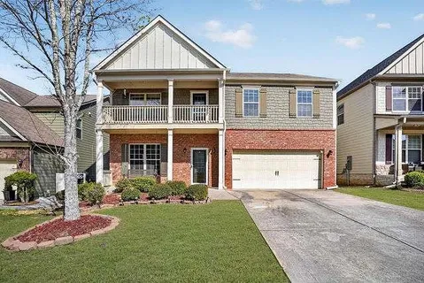 a front view of a house with a yard and porch