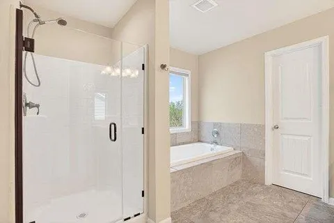 a bathroom with a bathtub and a shower