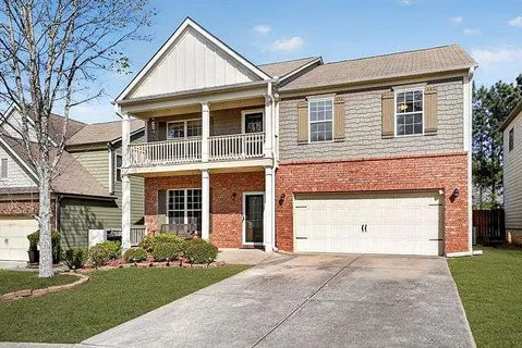 a front view of a house with a yard and garage