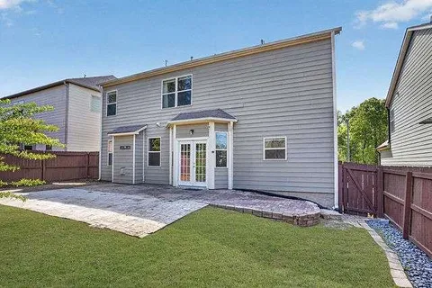 a view of a house with a yard and furniture