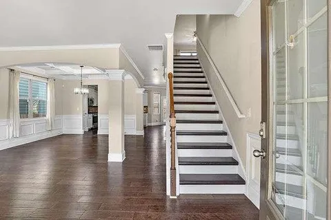 a view of entryway with wooden floor and stairs