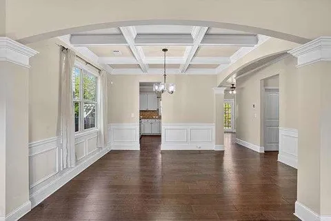 a view of a big room with wooden floor windows and entryway