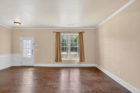 wooden floor in an empty room with a window
