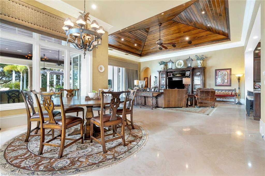 14927 Celle Way Naples, FL 34110 - Photo 11 of 31 a view of a dining room with furniture a chandelier and chandelier