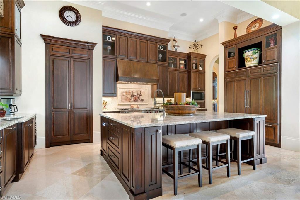 14927 Celle Way Naples, FL 34110 - Photo 13 of 31 a kitchen with a table and chairs in it