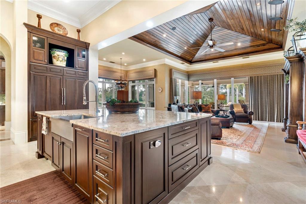 14927 Celle Way Naples, FL 34110 - Photo 14 of 31 a dining hall with stainless steel appliances granite countertop a stove and cabinets