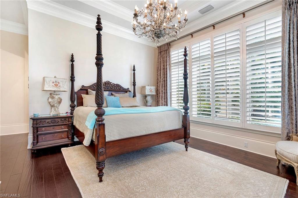 14927 Celle Way Naples, FL 34110 - Photo 17 of 31 a bedroom with a bed wooden floor and window