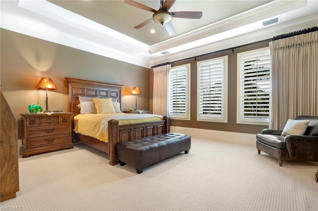 14927 Celle Way Naples, FL 34110 - Photo 18 of 31 a bedroom with a bed and a couch