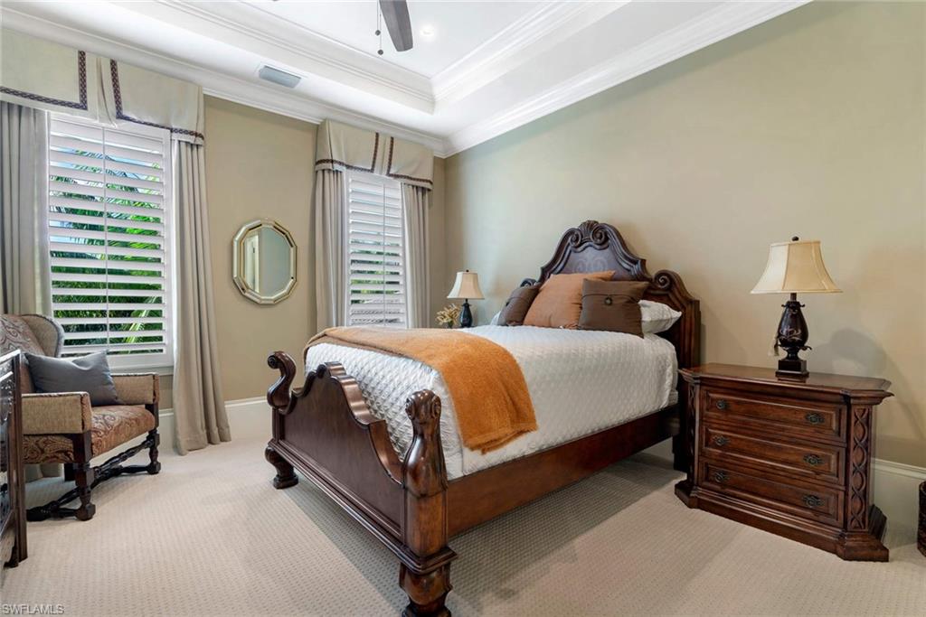 14927 Celle Way Naples, FL 34110 - Photo 19 of 31 a bedroom with a bed and a chandelier