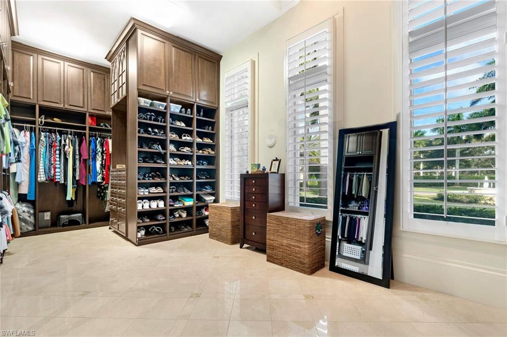 14927 Celle Way Naples, FL 34110 - Photo 23 of 31 a view of walk in closet with clothes and shoes