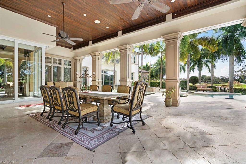 14927 Celle Way Naples, FL 34110 - Photo 25 of 31 a dining room with furniture and a garden