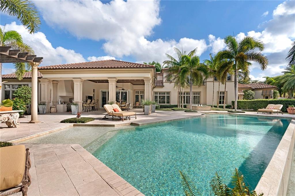 14927 Celle Way Naples, FL 34110 - Photo 27 of 31 a view of swimming pool with outdoor seating and house in the background