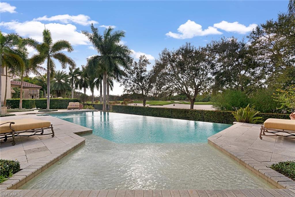 14927 Celle Way Naples, FL 34110 - Photo 28 of 31 a view of a swimming pool with a patio and a yard