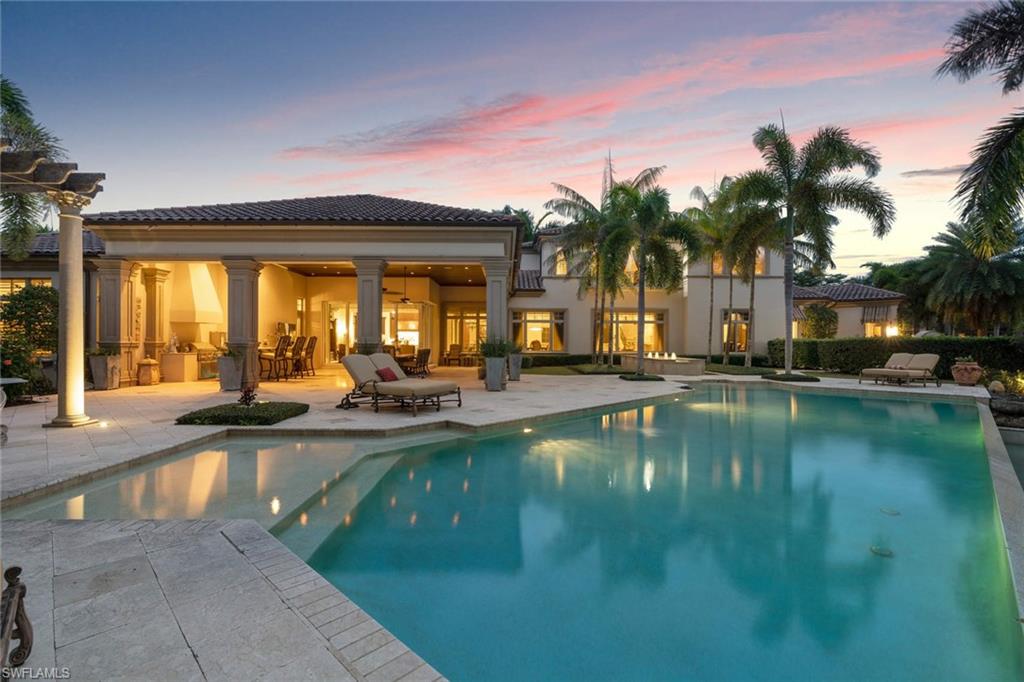 14927 Celle Way Naples, FL 34110 - Photo 4 of 31 a view of swimming pool with outdoor seating and house in the background