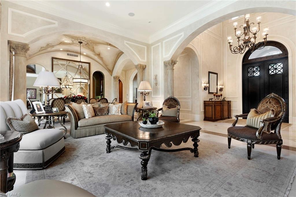 14927 Celle Way Naples, FL 34110 - Photo 8 of 31 a living room with furniture a large window and a chandelier