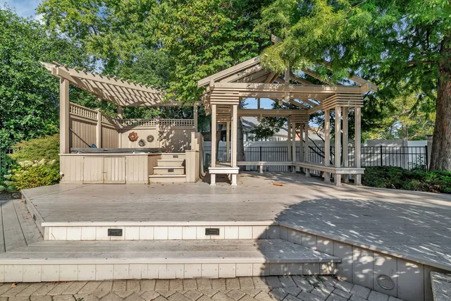 a front view of a house with a yard and potted plants