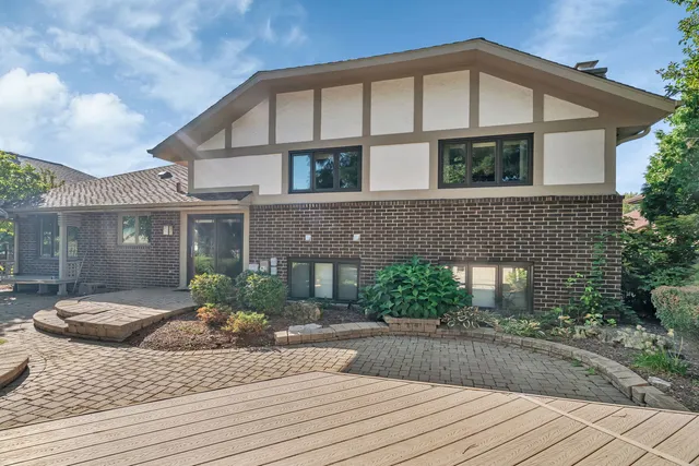a front view of a house with a yard and potted plants