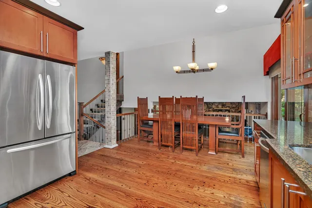 a dining room with furniture a chandelier and wooden floor