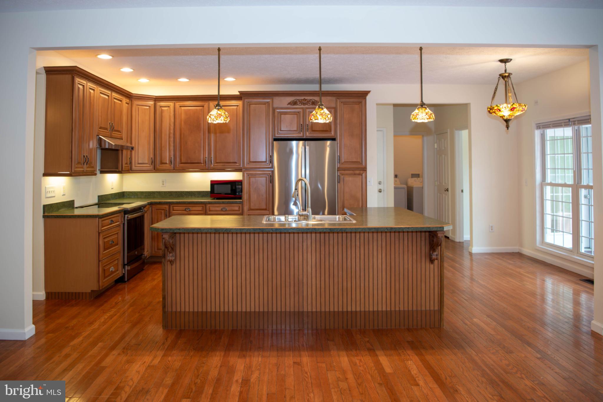 792 Forest Glen Road Moorefield, WV 26836 - Photo 30 of 146 Elegant kitchen with rich wood tones.
