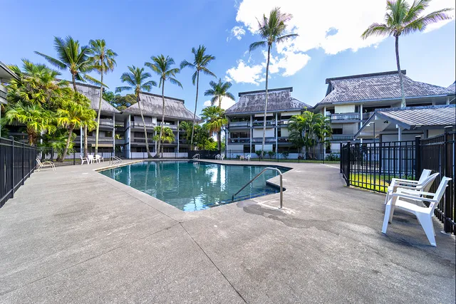 a swimming pool view with a outdoor seating