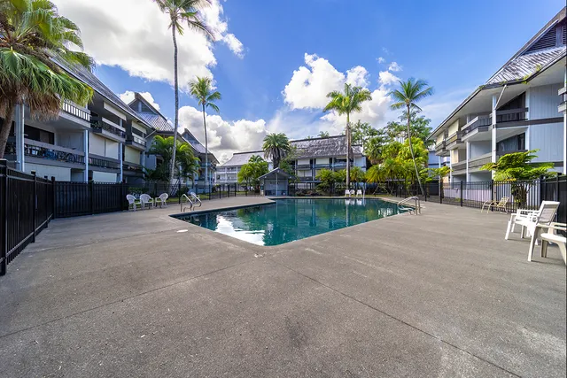 a view of a building with sitting area and garden