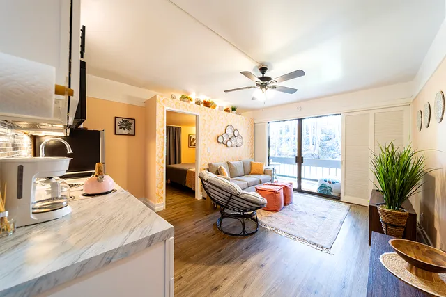 a living room with furniture and wooden floor