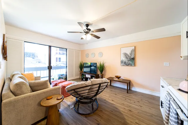 a living room with furniture a table and a large window