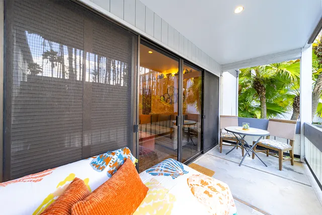 a bedroom with a bed and a balcony