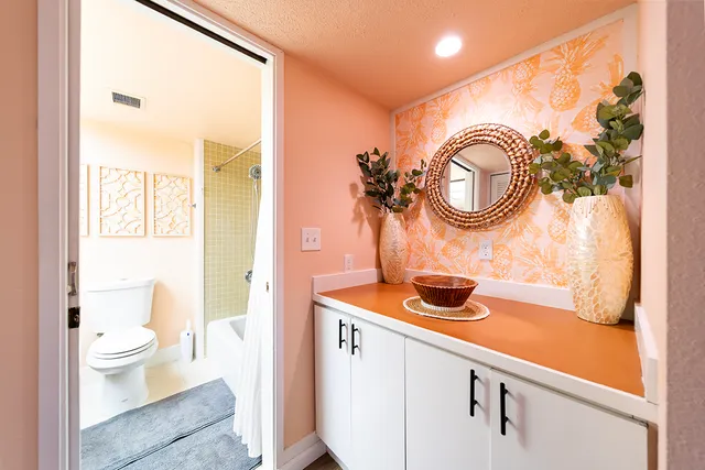 a bathroom with a sink a toilet and a mirror