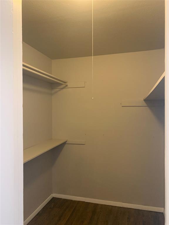4606 Monarch Street, Unit 215 Dallas, TX 75204 - Photo 12 of 13 Walk in closet featuring dark wood-style flooring