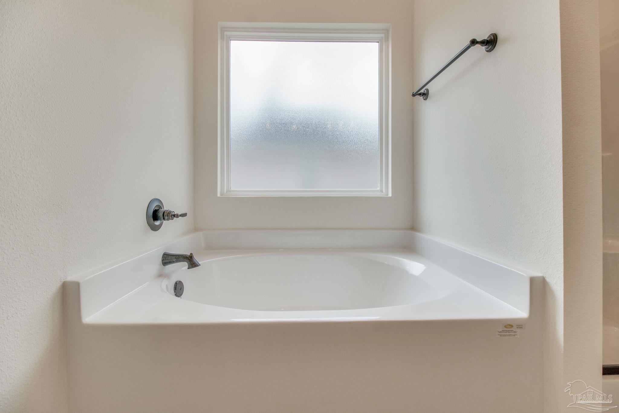 4310 Watkins Street Pace, FL 32571 - Photo 41 of 58 a white bath tub sitting next to a window