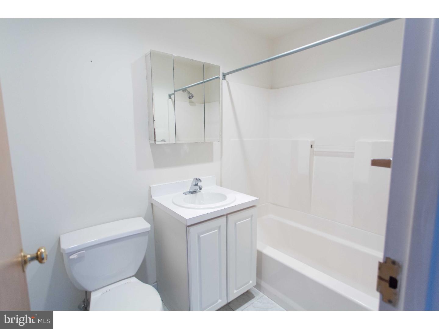 1600-7 Walnut Street, Unit 706 Philadelphia, PA 19103 - Photo 15 of 25 a bathroom with a sink a toilet and shower