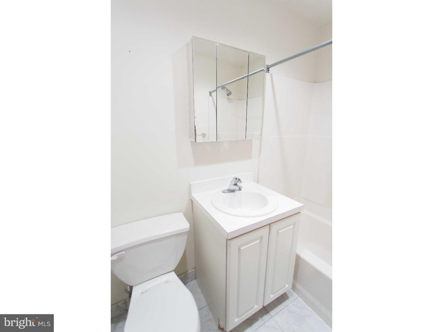 1600-7 Walnut Street, Unit 706 Philadelphia, PA 19103 - Photo 18 of 25 a bathroom with a toilet a sink and a mirror