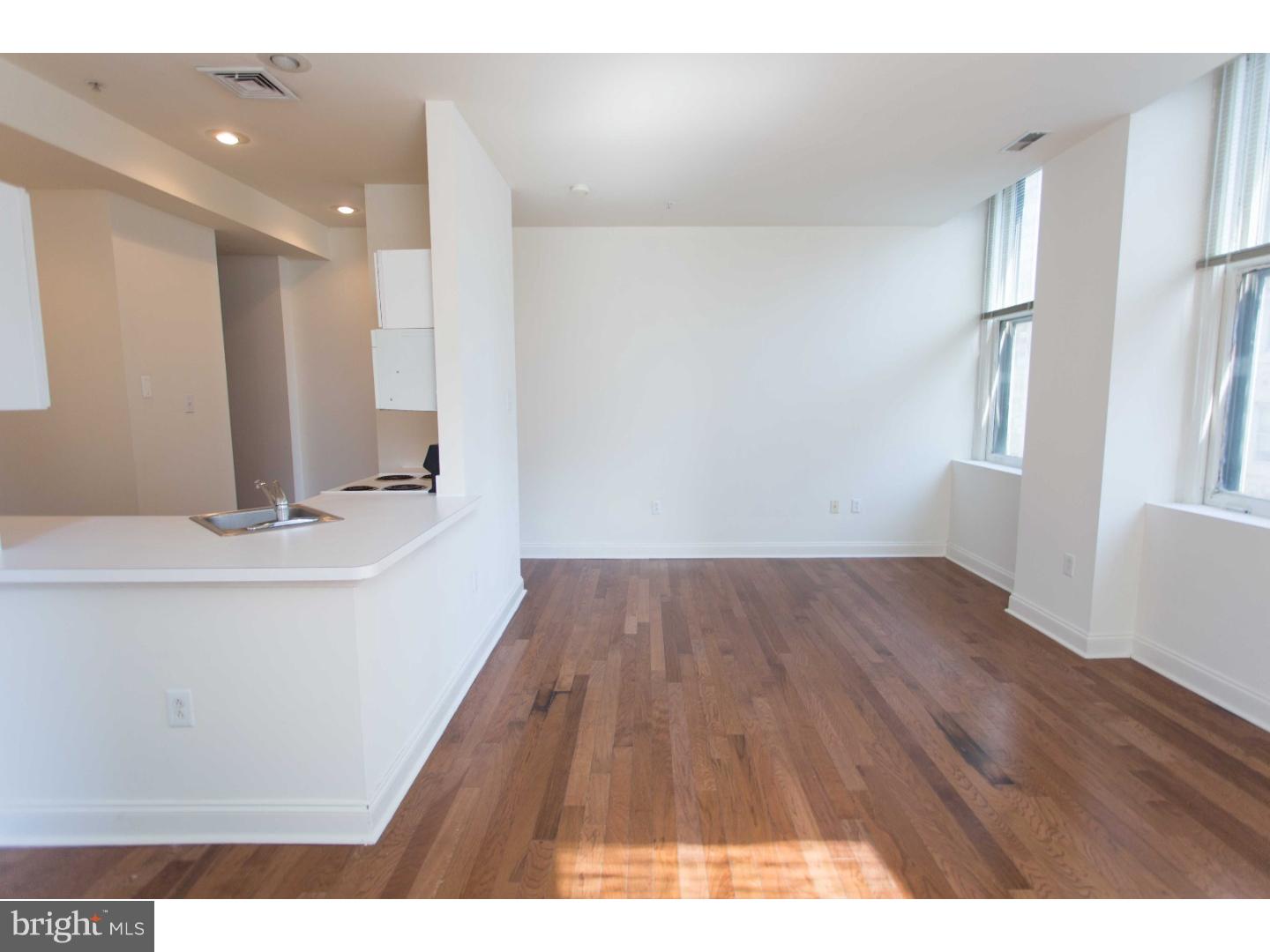 1600-7 Walnut Street, Unit 706 Philadelphia, PA 19103 - Photo 6 of 25 a view of wooden floor and windows in a room