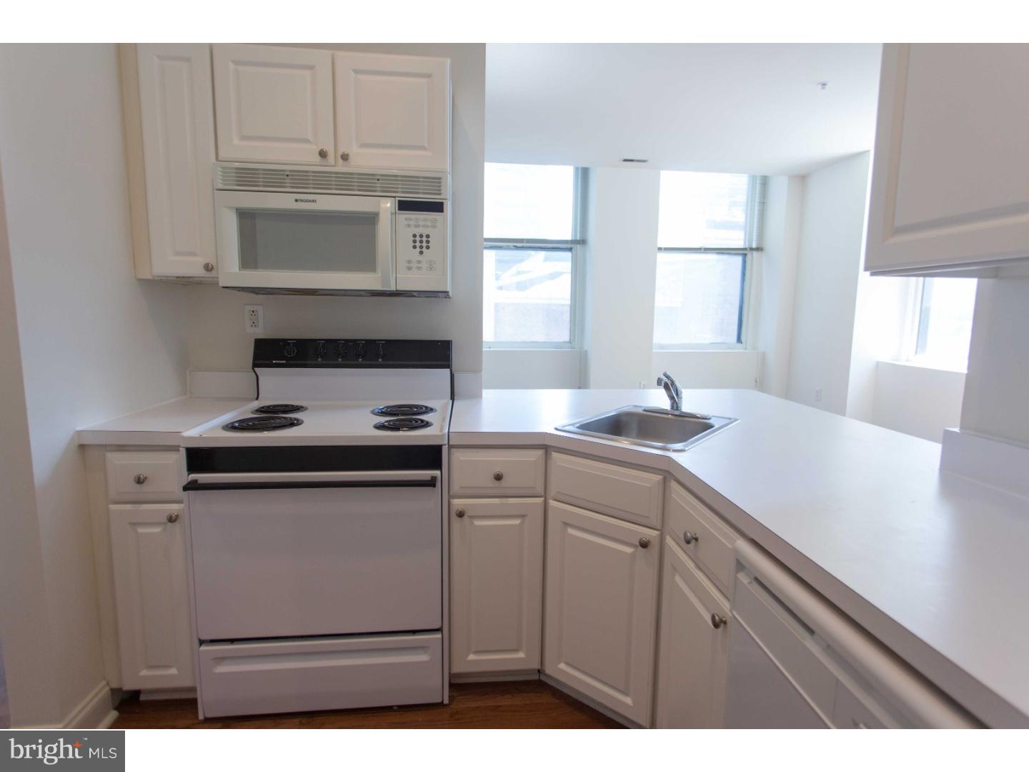 1600-7 Walnut Street, Unit 706 Philadelphia, PA 19103 - Photo 10 of 25 a kitchen with stainless steel appliances granite countertop a sink a stove and white cabinets