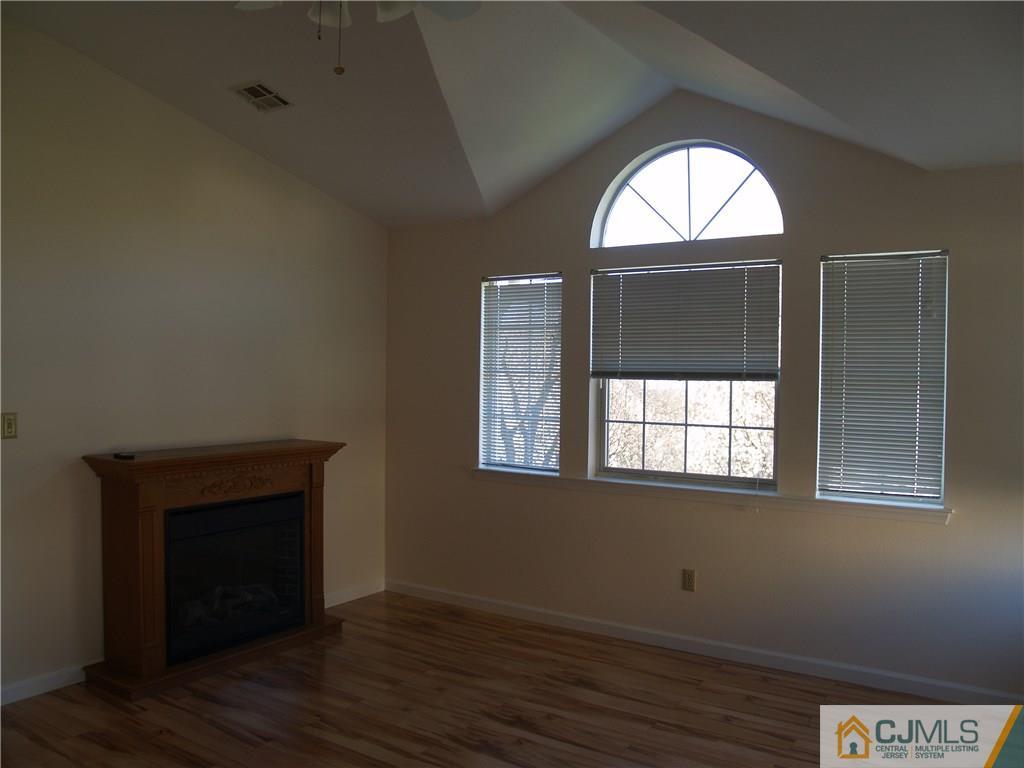 18 High Pond Lane, Unit 18 Bedminster, NJ 07921 - Photo 11 of 19 an empty room with wooden floor windows and closet