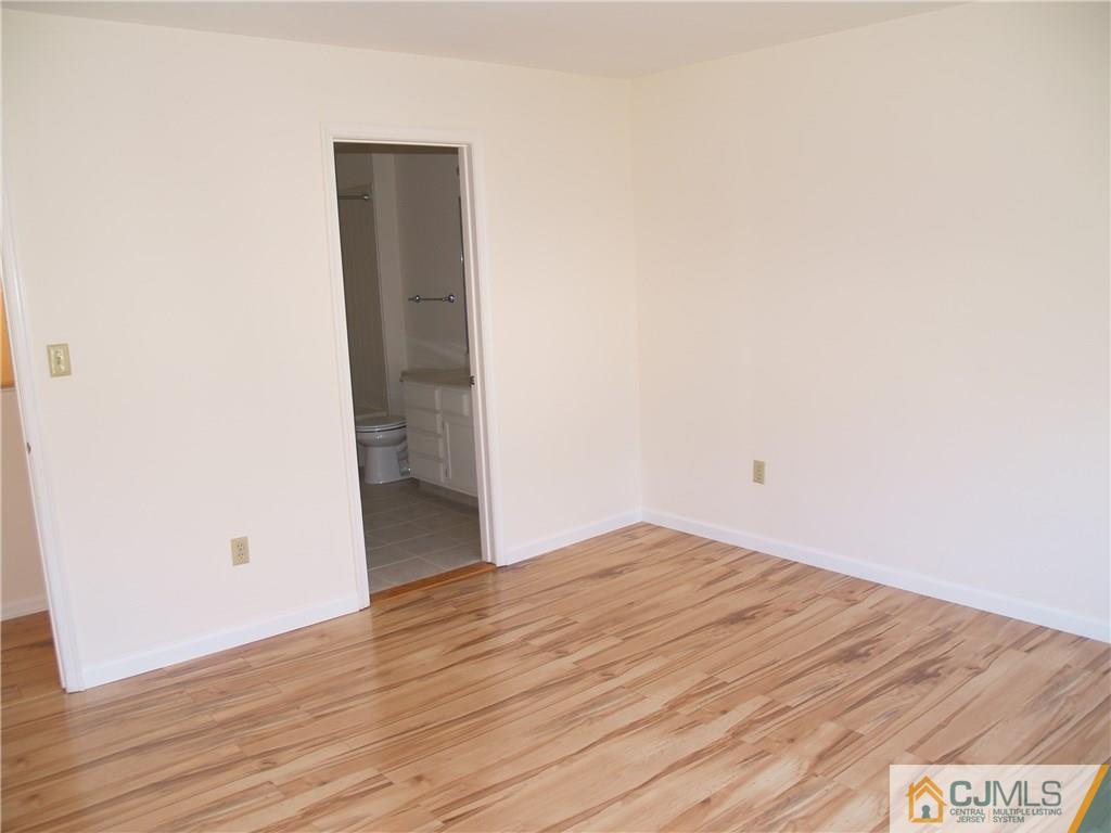 18 High Pond Lane, Unit 18 Bedminster, NJ 07921 - Photo 15 of 19 an empty room with wooden floor and entrance