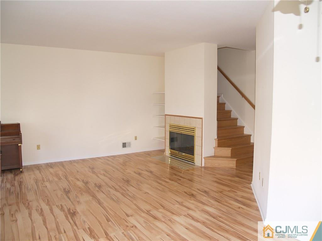 18 High Pond Lane, Unit 18 Bedminster, NJ 07921 - Photo 4 of 19 a view of a livingroom with wooden floor and staircase